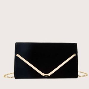 Minimalist black clutch bag with chain